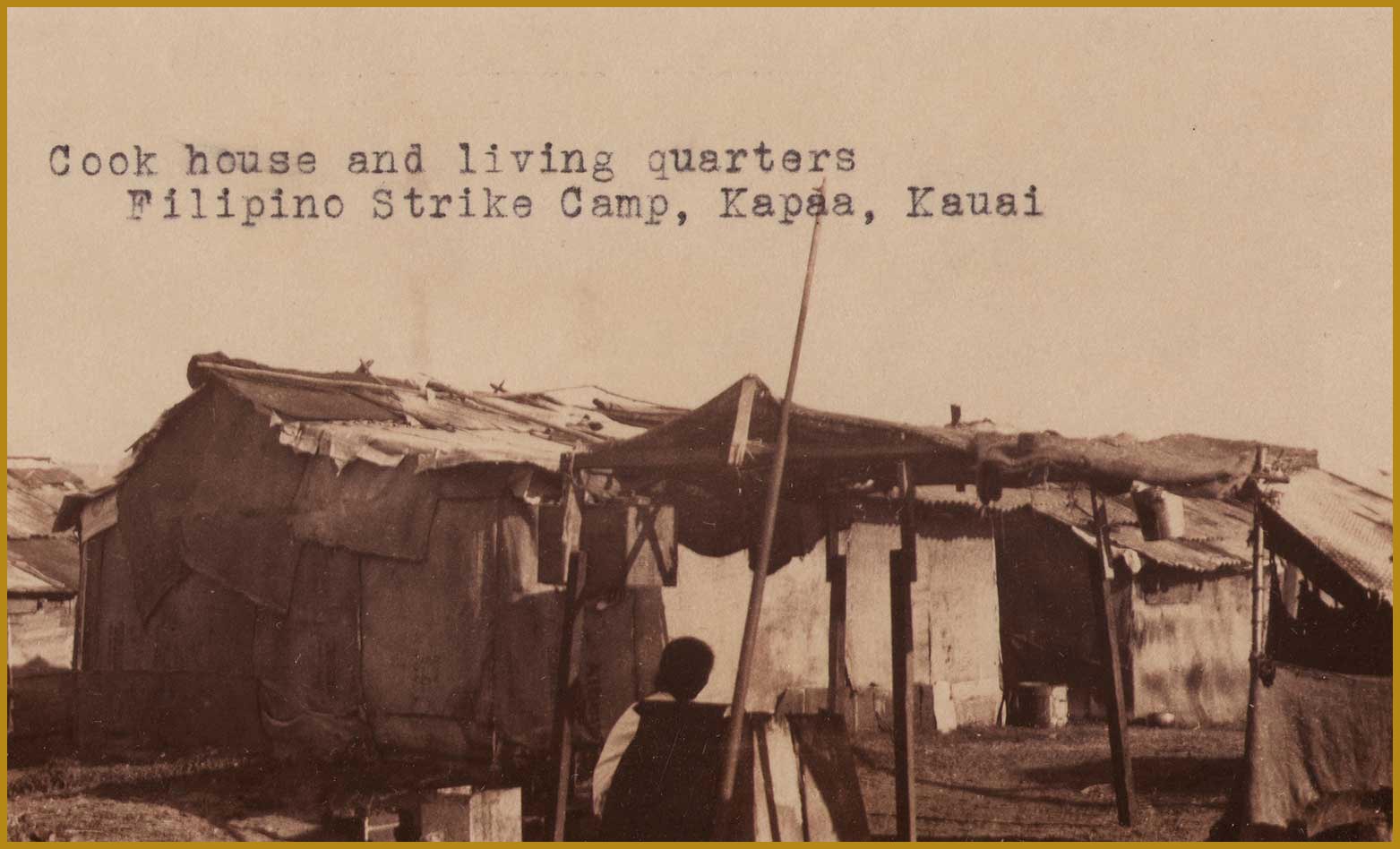 Large white tents made with wood and cloth. Label reads "Cook house and living quarters Filipino Strike Camp, Kapaa, Kauai."