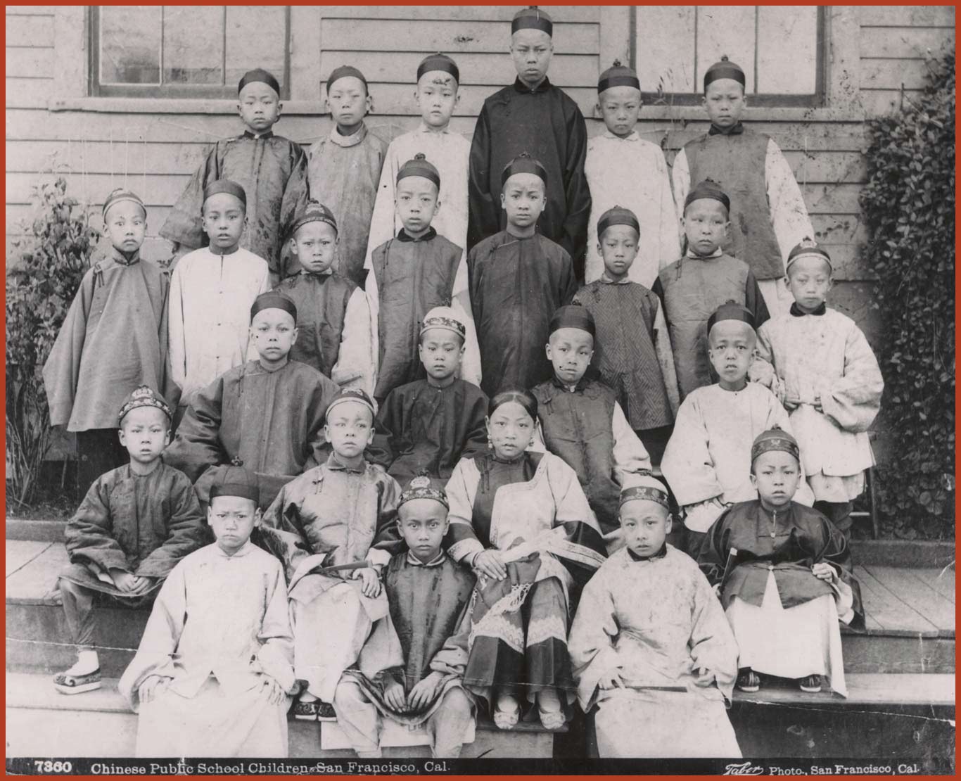 Mamie and her fellow classmates at the Chinese Public School in San Francisco posing for a group photo. All students are wearing traditional Chinese attire.