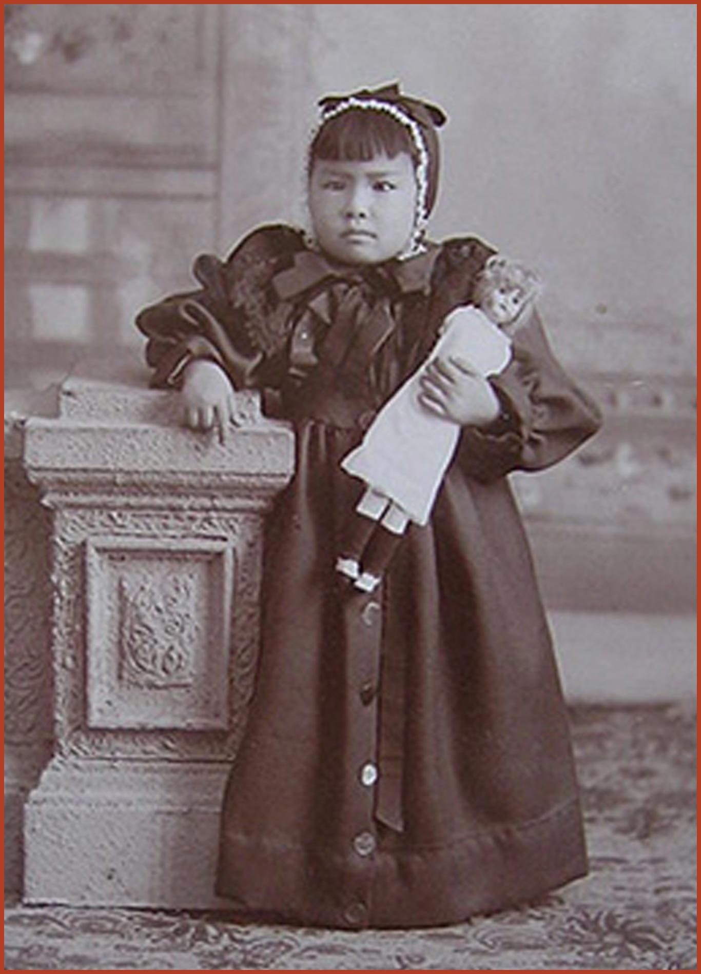 Gertrude Ella Tape, holding her doll.