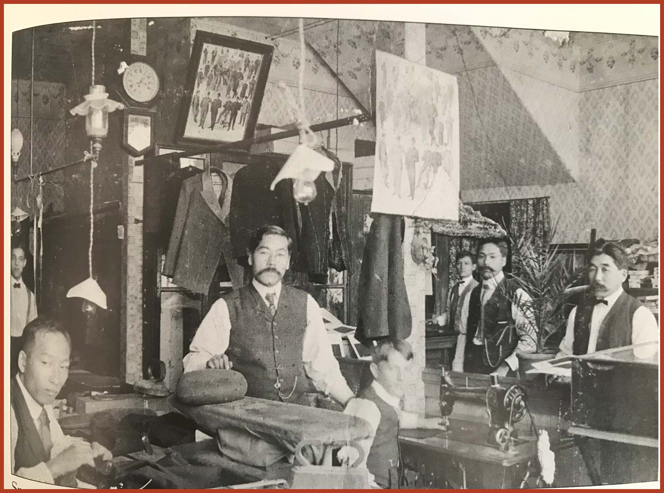 A group of tailor At the Matsuura Company Tailors pause their work to pose for a photo.