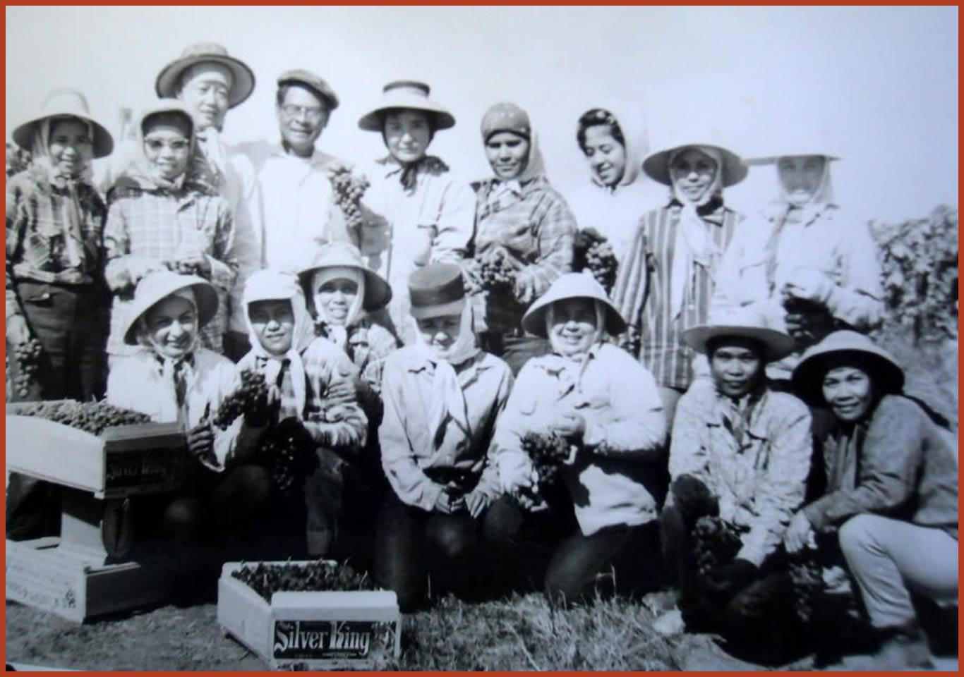 A group of fifteen female farm workers and the Lucas Camp foreman pose for a photo.
