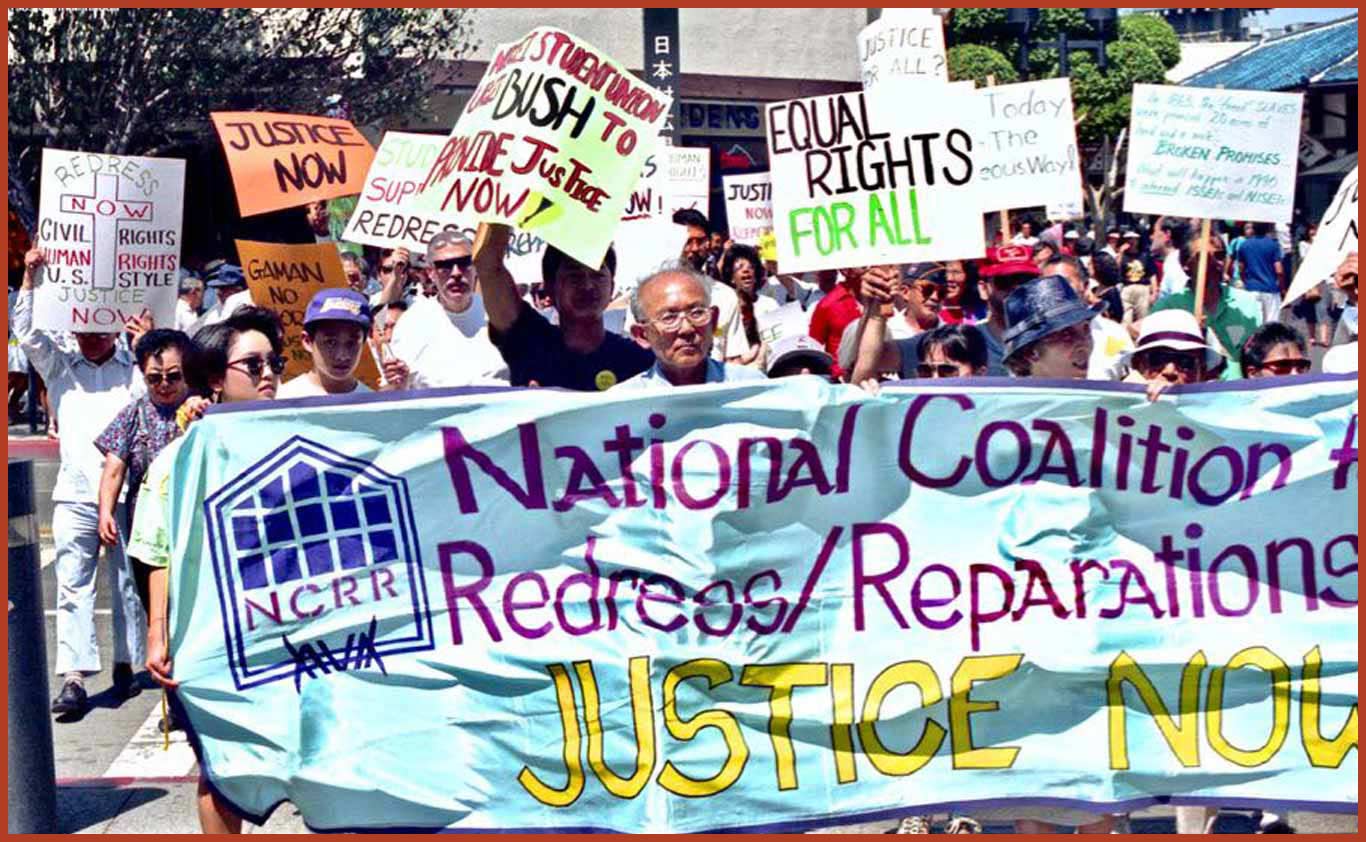 Individuals marching holding signs and banner. A large banner in the front reads "National Coalition for Redress/Reparations Justice Now." Other signs read "Equal Rights for All" and "Redress Now, Civil Rights, Human Rights, U.S. Style, Justice Now."