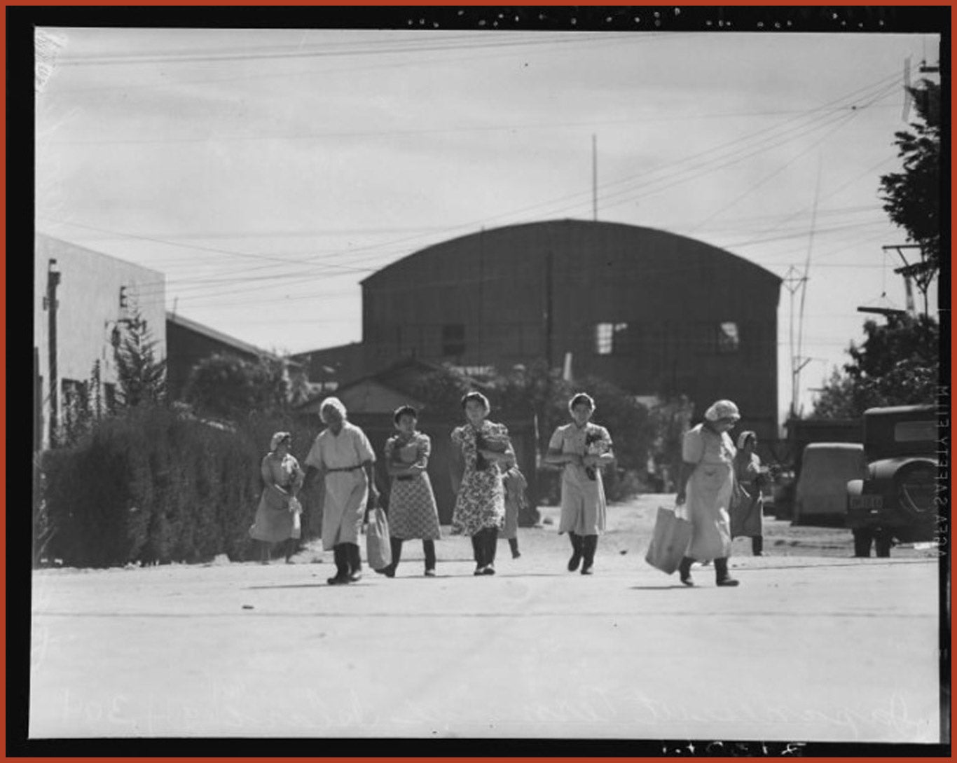 Seven women leave the Japanese fishing cannery after a days of work.