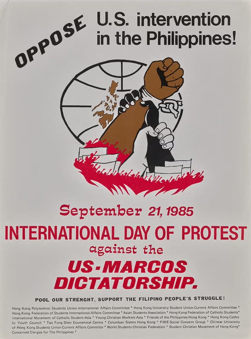 In the center, a brown arm shackled at the wrist and held by a black hand, which is held at the wrist by a white hand. Map of Filippines behind them.