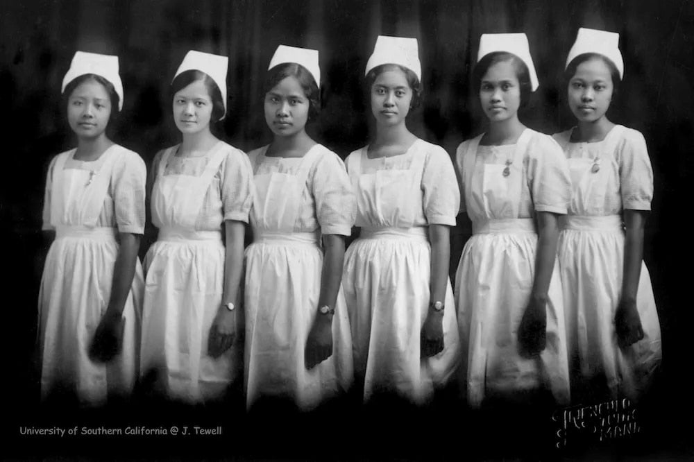Six female graduates of St. Paul's Hospital nursing program pose in a formal black and white portrait, dressed in nurse's cap and uniform.