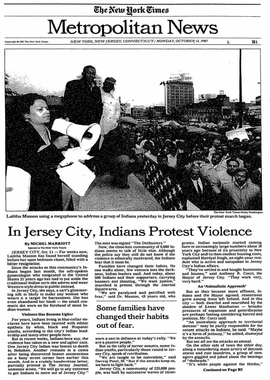Article titled "In Jersey City, Indians Protest Violence." Photograph shows a woman standing on stage with megaphone in hand and addressing the crowd.
