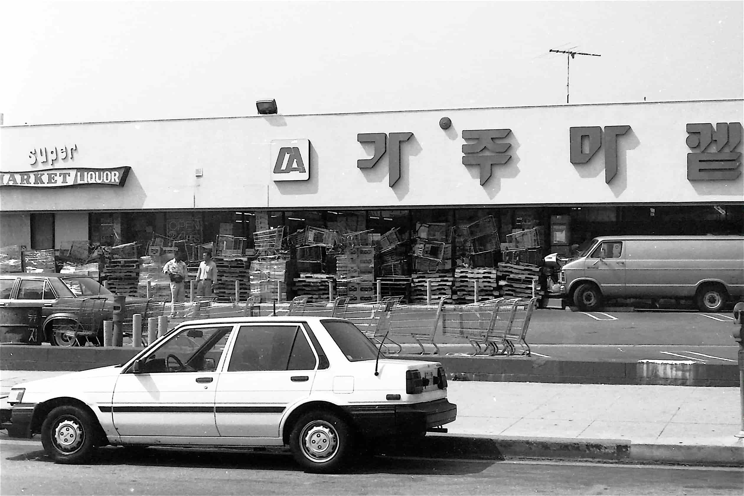 A Korean market in Los Angeles is boarded up with shipping pallets and shopping carts.