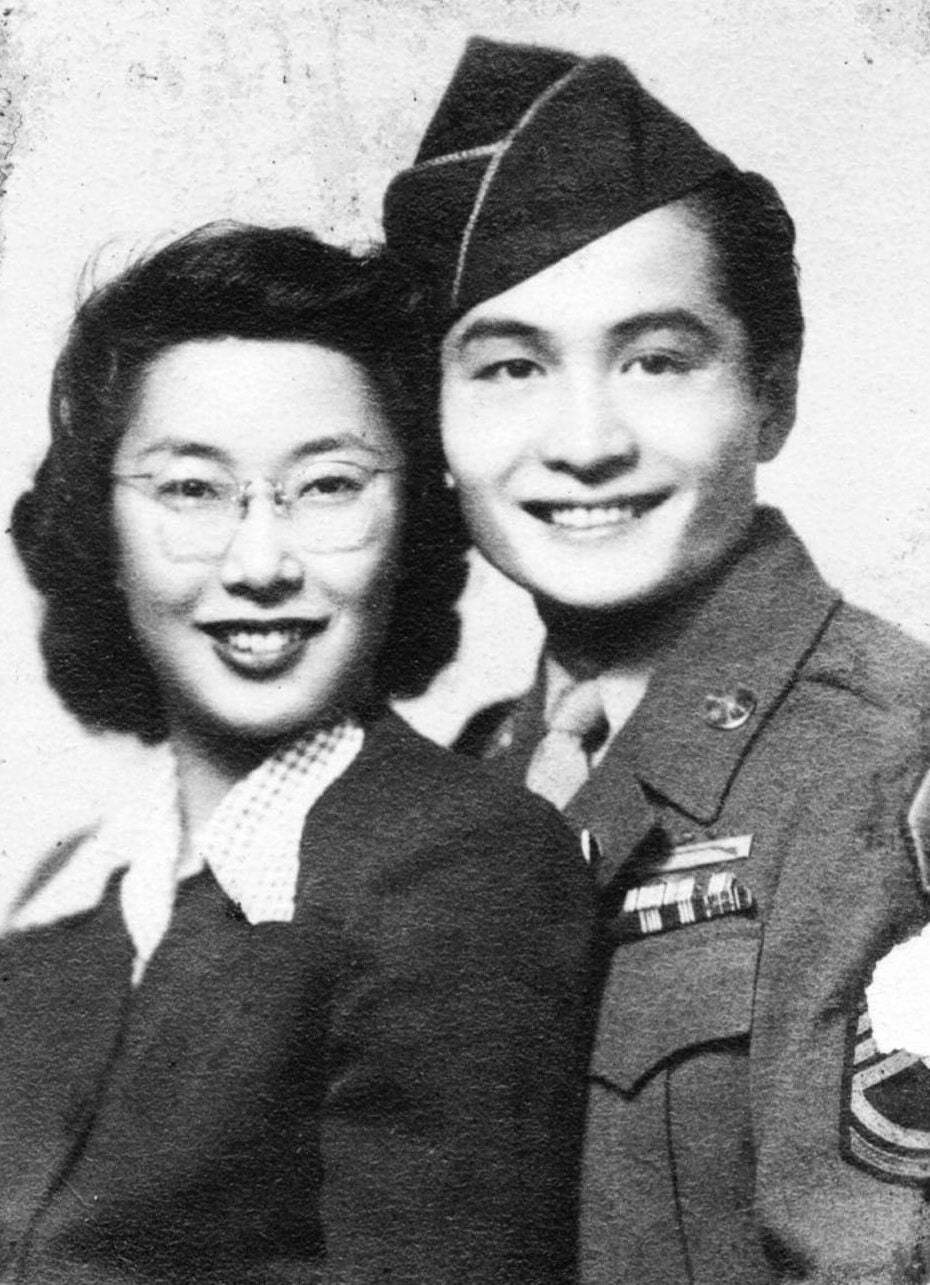 Yuri, in glasses, suit jacket and blouse, and Bill Kochiyama, in U.S. Army dress uniform, pose together for wedding day portrait.