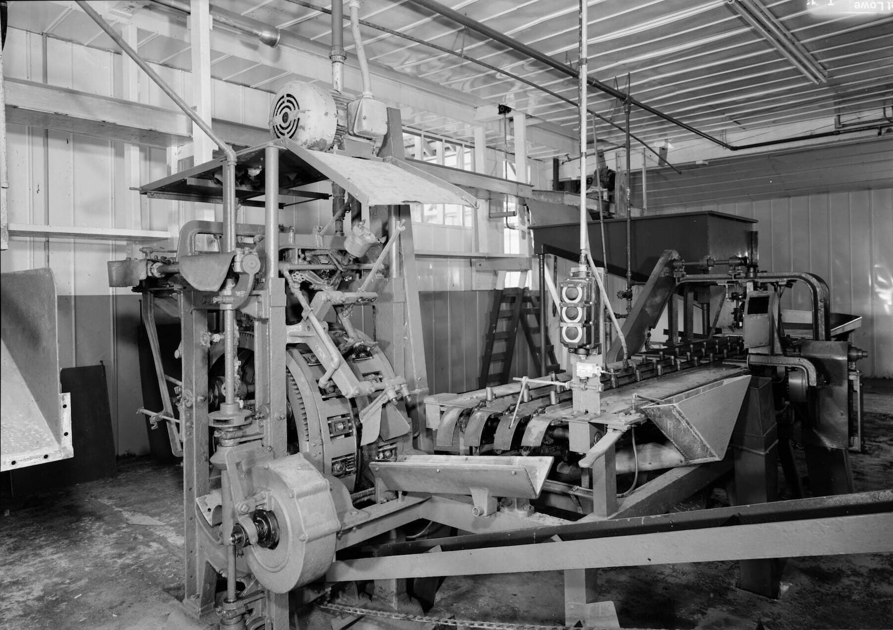 The inside of Kake Salmon Cannery featuring a machine that can replace manual labor.