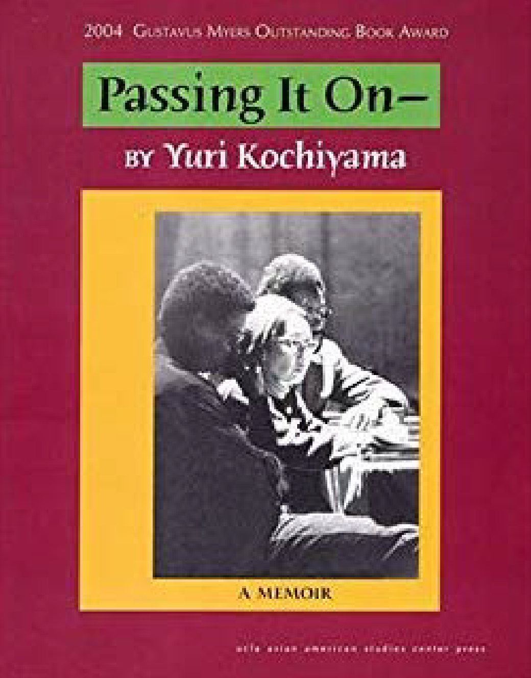 The red-and-yellow-matted cover of Yuri’s memoir shows a profile of her seated between two people.