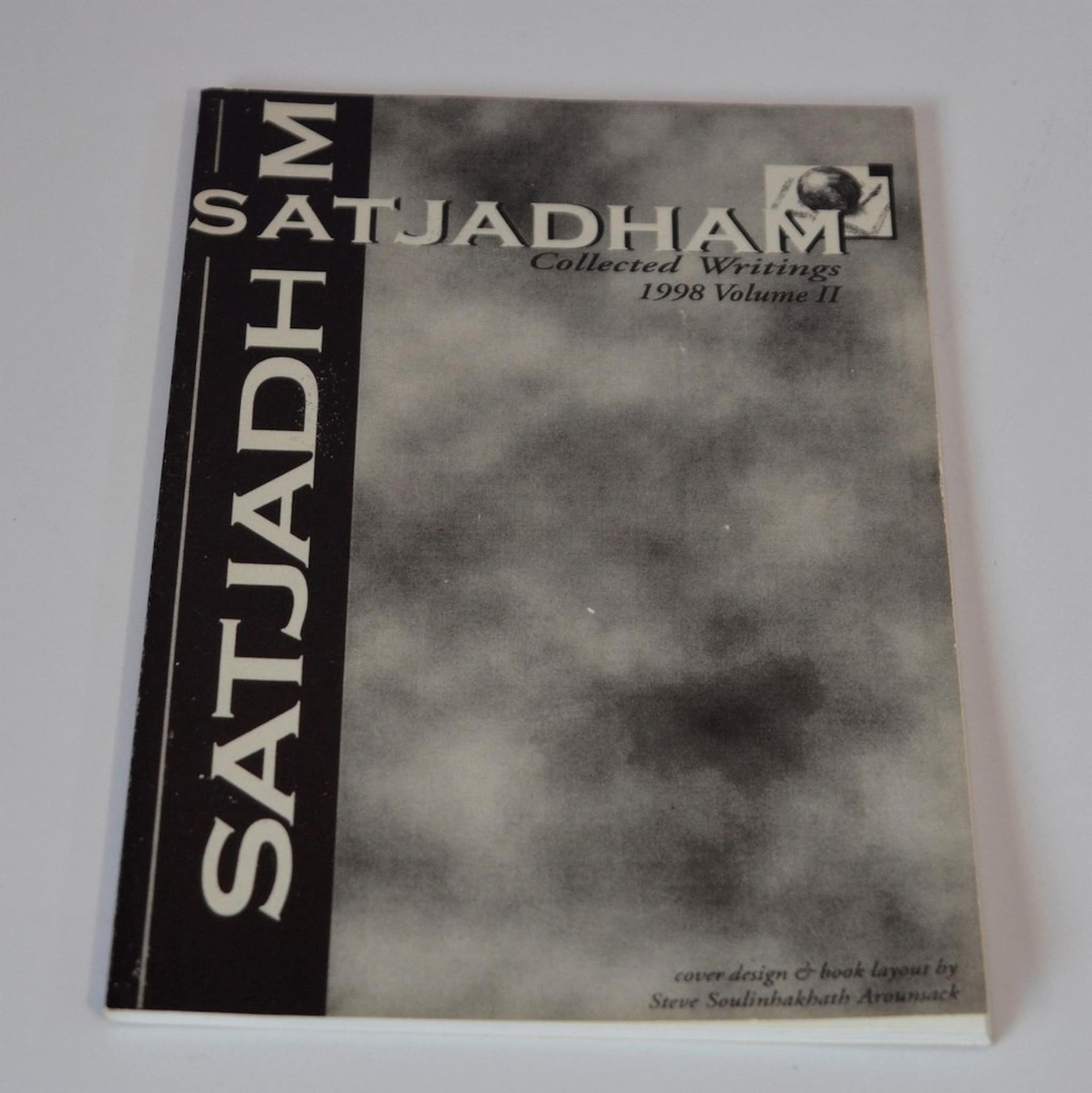 Cover of SatJaDham's collected writings with clouds in black and white on the cover.
