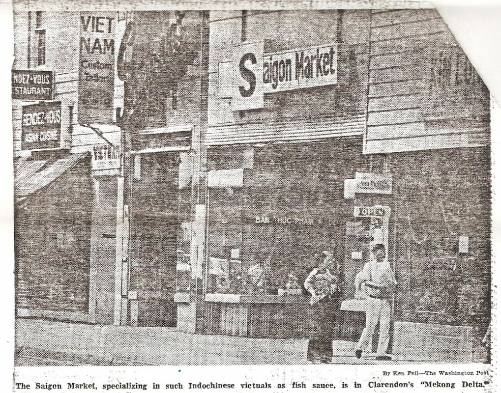 This Washington Post clipping shows an image of Saigon Market. A Vietnamese family walks past the storefront.