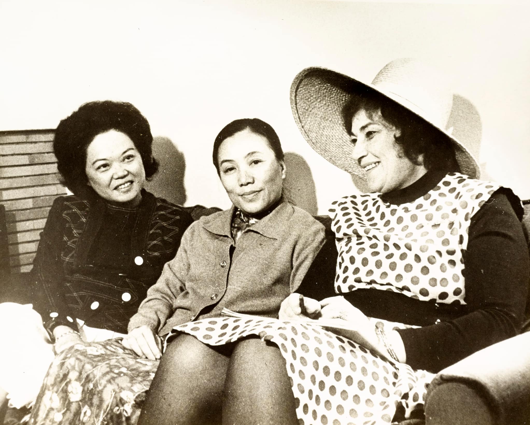 Mink, left, sits with politicians: Nguyen Thi Binh, woman with collared sweater, center, and Bella Abzug, woman in polka dot dress and hat, right.
