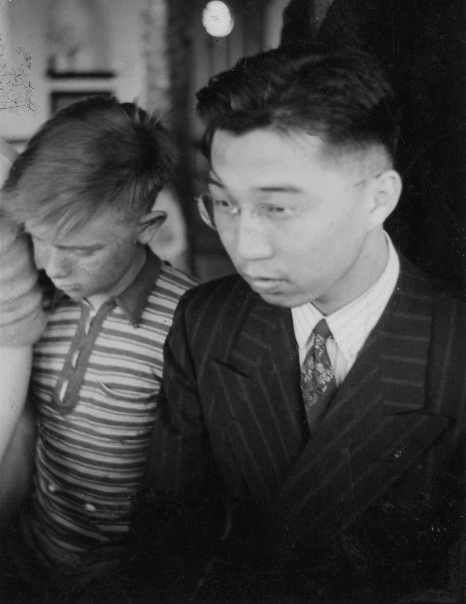 Japanese American activists Gordon Hirabayashi on the right and Bill Schmoe to his left walk together.
