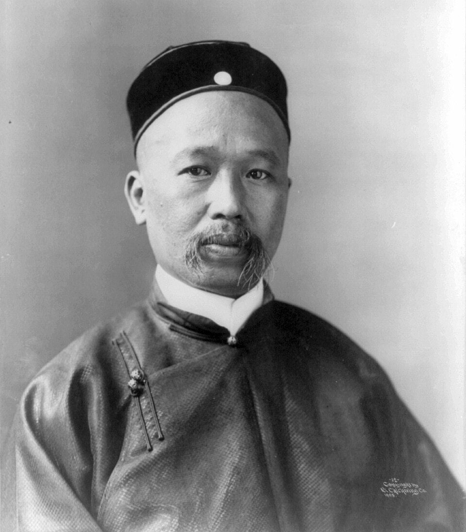 Sepia-toned photograph: Portrait of Kang Youwei wearing a Chinese jacket and cap.