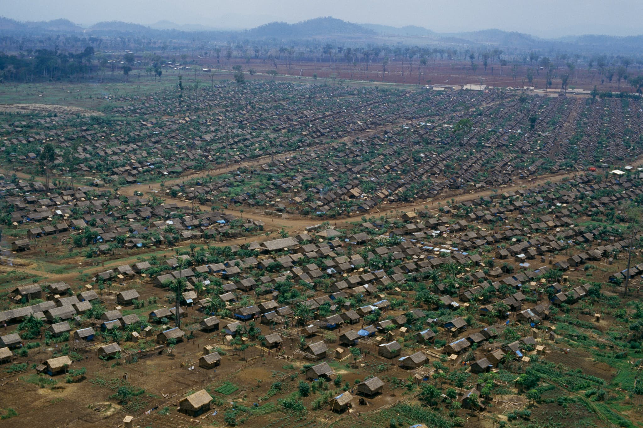 Aerial view of refugee camp Khao-I-Dang on the Thailand-Cambodia border. Shelters are built closely next to each other in a grid pattern.