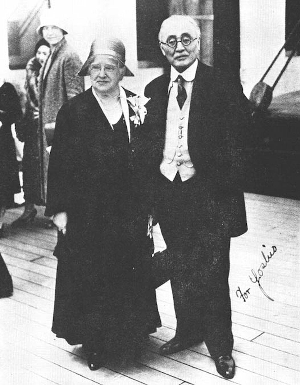 Japanese diplomat Inazo Nitobe standing with his white American Quaker wife Mary Elkinton formally dressed at an event.