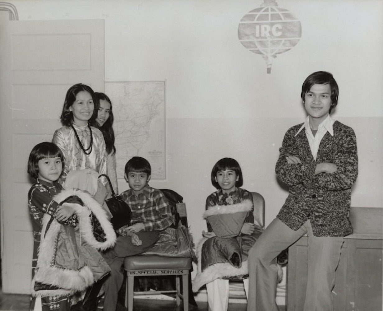 A casual snapshot of a smiling family of Vietnamese refugees at the relocation center at Fort Chaffee, Arkansas.