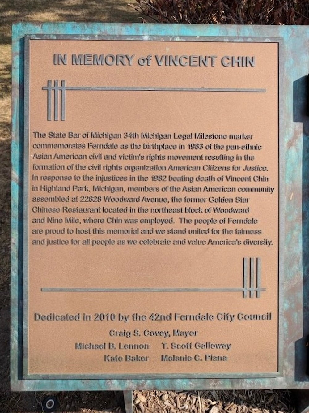 Outdoor plaque with inscription "In Memory of Vincent Chin" at top. Text below describes significance of plaque's location and commemoration details.