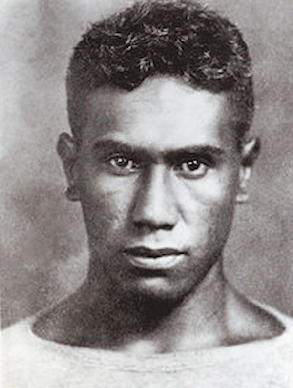A close-up of Joe Kahahawai shows an expression that is a mixture of fear and anger.