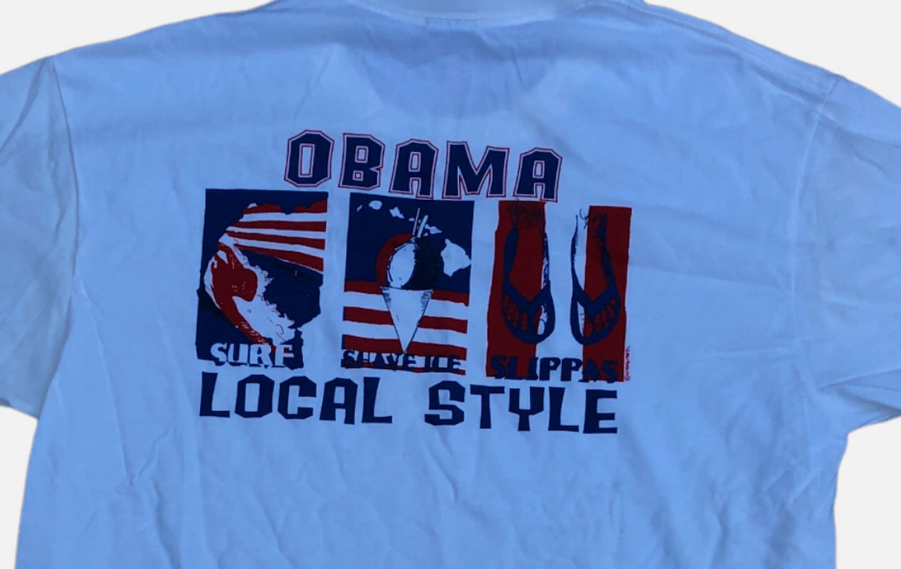 A blue t-shirt supporting surfing, shave ice, slippers, and Obama.