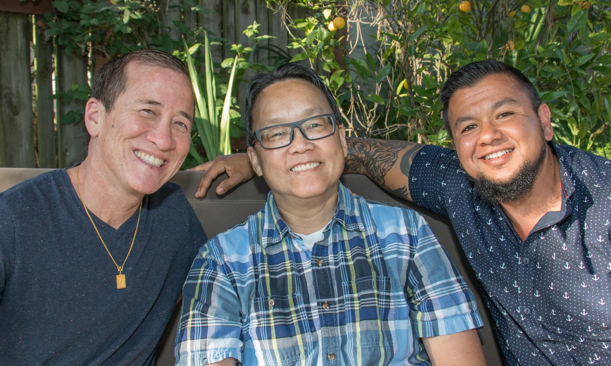Chino Scott-Chung, Willy Wilkinson and Jai DeLotto in a relaxed pose together with trees in the background.