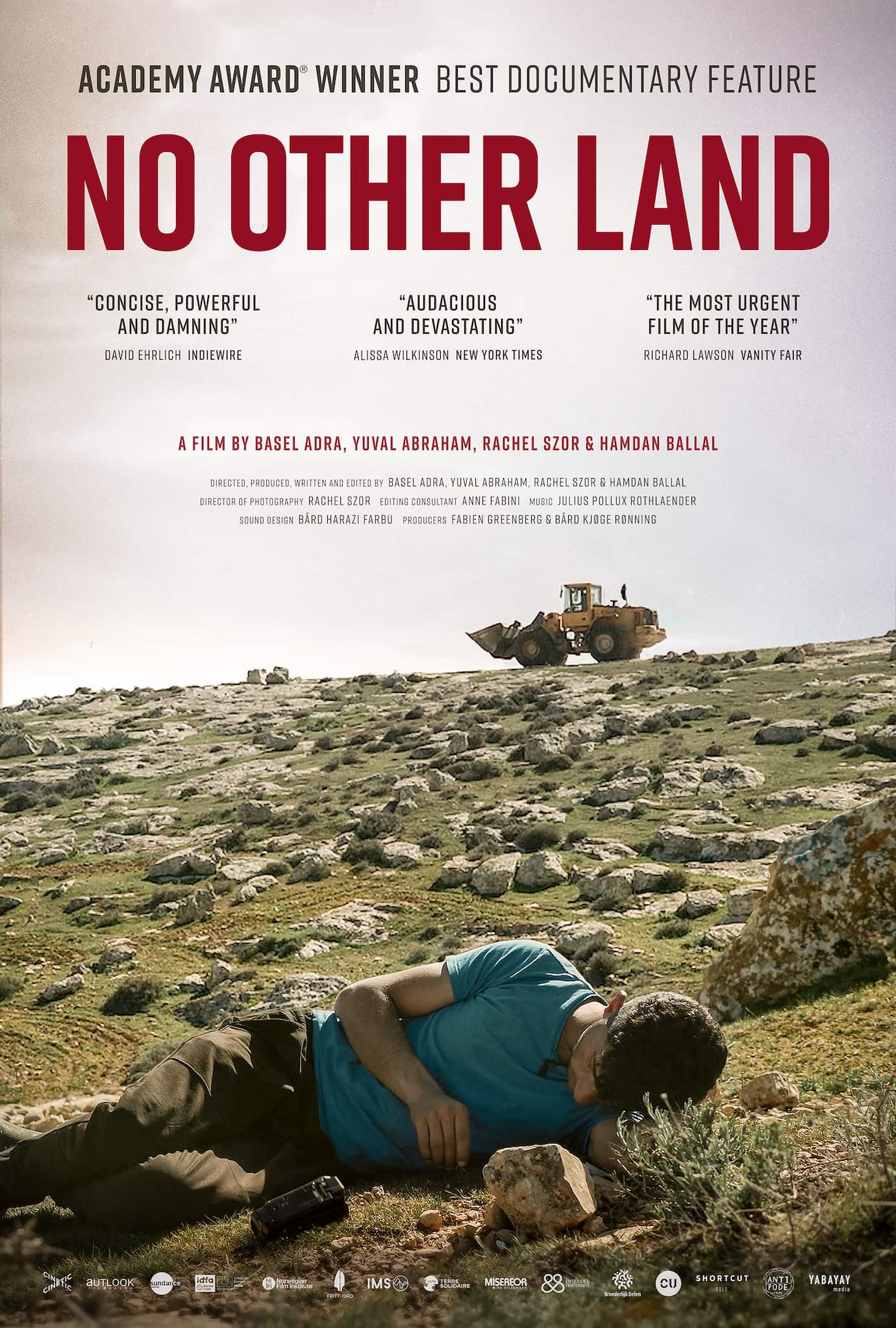 Poster for No Other Land, with film's name in red at top. In foreground, a man lies on rock-strewn ground while a bulldozer looms in distance.